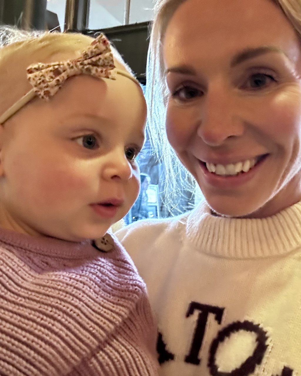 Angela Kocek, founder of Dune Seven, holding her daughter Chloe